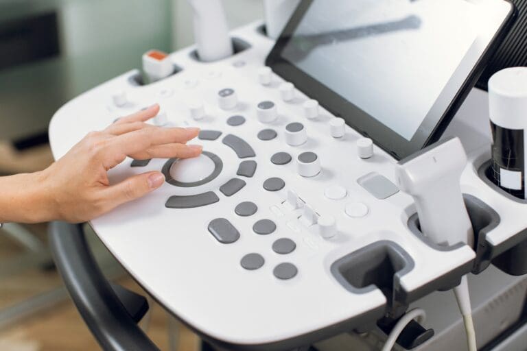 Close up cropped shot of modern medical device, ultrasound machine scanner at work.